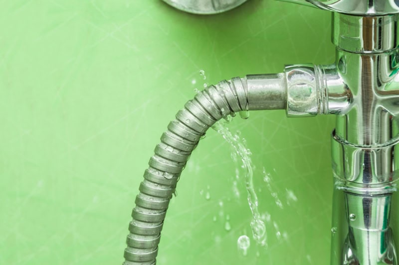 How To Detect a Sewer Line Leak. Damaged leaking water tap hose in the bathroom of house, flat or other place. Plumbing concept.